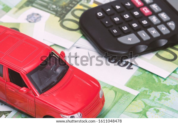 red\
car and money, euro and dollars. insurance\
concept