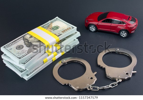  Red car  money handcuffs. \
breaking the law auto dealer,  Car Dealer Fraud Law\
concept.