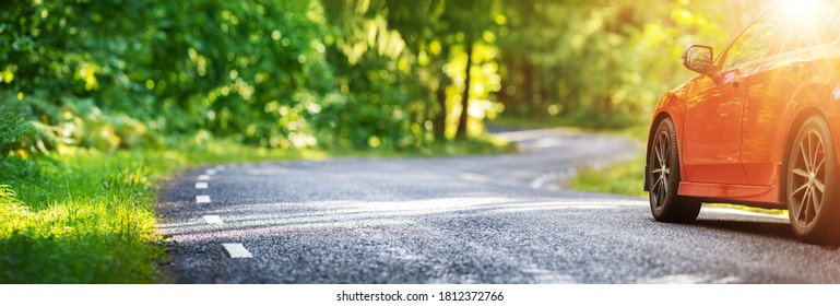 Red Car On Asphalt Road In Summer