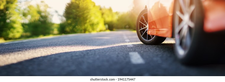 Red car on asphalt road in summer - Powered by Shutterstock