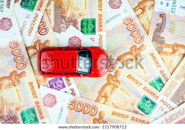 The red car\
is on the money, a Toy car on\
money
