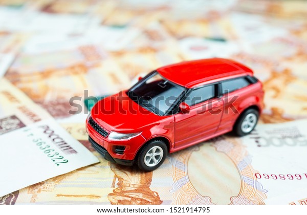 The red car\
is on the money, a Toy car on\
money