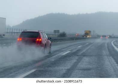 Red car on the rainy motorway