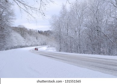 A Red Car On A Snowy Road