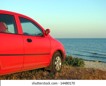 Red Car Parked At The Beach