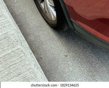 Red Car Parked On The Curb In The City