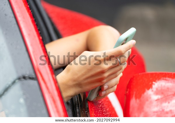 Red car and the phone. Calls on the phone. Modern trendy\
youth style. 