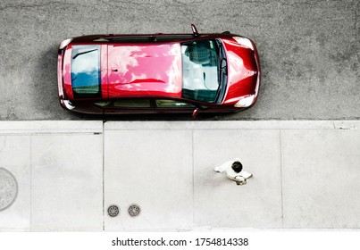 Red Car Pictured From Above, Pedestrian Walking Below