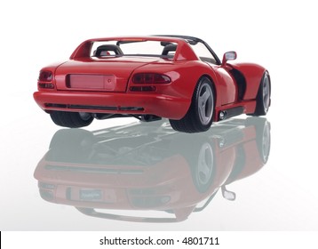 Red car with reflection. Studio shot.