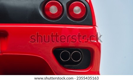 Red car showing the passenger side brake light