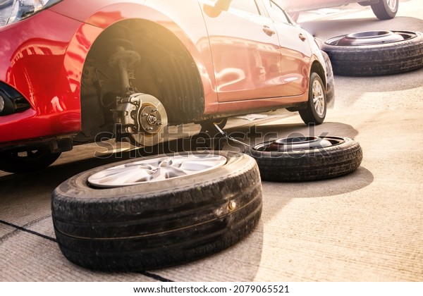 Red\
car in station repair service car maintenance for industry rubber\
wheels tire vehicle auto car change garage repairing problem\
transport automobile service automotive\
maintenance