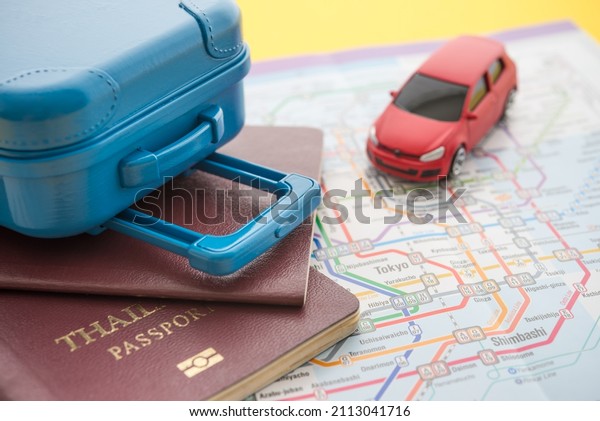 Red\
car, suitcase and passport on map background. Travel insurance\
covers loss suitcase, flight delays, cancellations, evacuations and\
medical expenses. Travel insurance, planning\
concept.