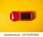 red car toy on yellow background