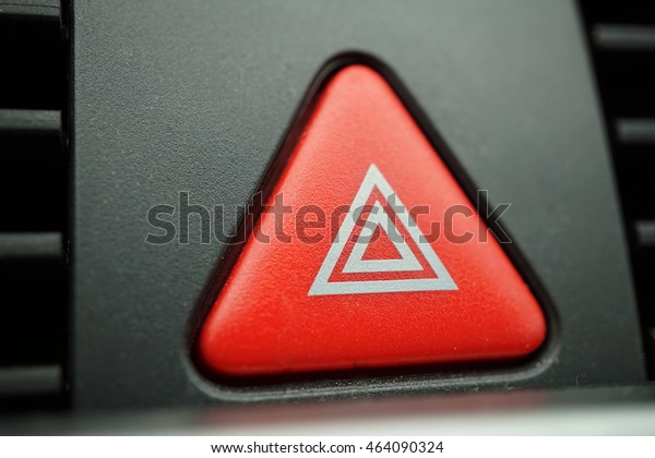 Red car Warning button with a white triangle\
switching all the vehicle outdoor indicators as a symbol of \
caution, warning and potential\
danger