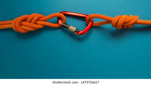 Red Carbine With Clutch. Equipment For Climbing And Mountaineering. Safety Rope. Knot Eight.