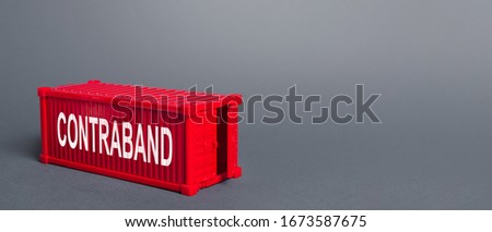Red cargo shipping container with the word Contraband. Traffic of prohibited goods and products, bypassing customs, smuggling. Corruption, violation of the embargo, circumvention of sanctions. Import
