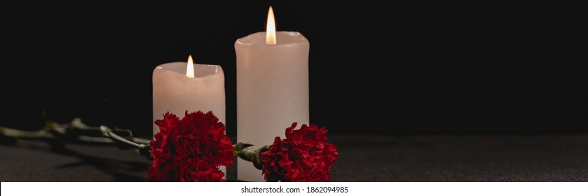 Red Carnation Flowers And Candles On Black Background, Funeral Concept, Banner