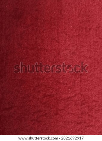 A red carpet background with a soft texture; red is synonymous with courage.