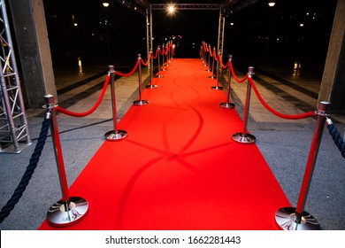 Red carpet with barriers and red ropes.