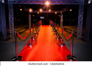 Red carpet with  barriers, velvet ropes and lights in the background - Powered by Shutterstock