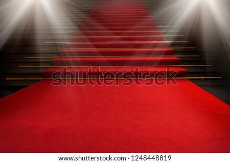 Red carpet on the stairs on a dark background. The path to glory, victory and success