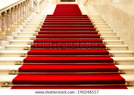Red carpet on the stairs in a luxury interior