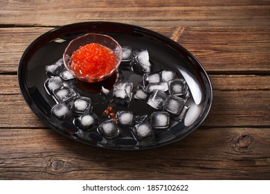 Red Carviar With Ice On Black Plate