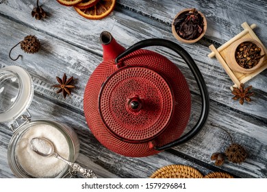 Red cast iron vintage teapot close up on vintage wood and brick surface top view - Powered by Shutterstock