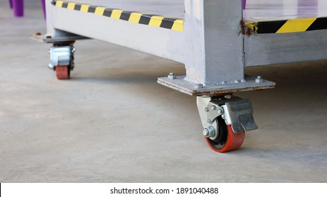 Red Caster Wheel Or Trolley Wheels. Heavy-duty Polyurethane Plastic Roller On Cement Deck With Copy Space. Select The Content And Close The Focus.