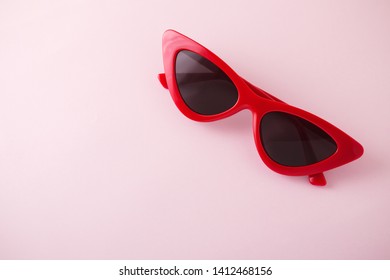 Red Cat Eye Sunglasses On Pink Background