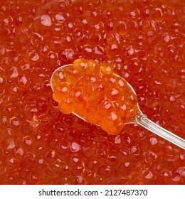 Red caviar eggs on a spoonful of backdrop red caviar close-up, delicacy seafood, top view - Shutterstock ID 2127487370