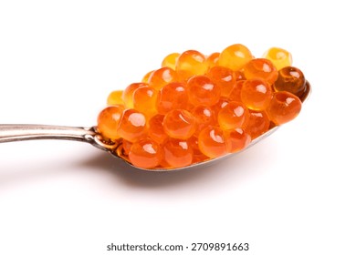 Red caviar in a silver spoon isolated on white background. Close-up of salmon fish roe. Delicatessen. Seafood backdrop. Chum salmon caviar macro shot.