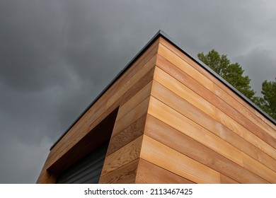 Red cedar wood facade architecture detail low angle view stormy sky background