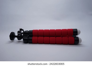 red cellphone tripod on a white background