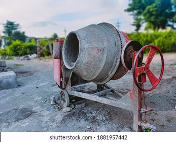 Red Cement Mixer With Remaining Cement Stuck To It