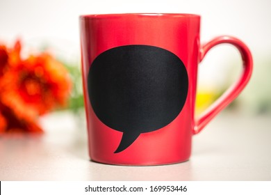 Red Ceramic Cup With Empty Chalk Board. Standing On A Kitchen Table. 