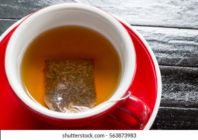 Red Ceramic Cup Of Tea Served With Tea Bag Soak In Hot Water