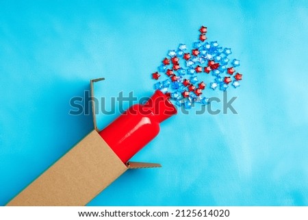 a red ceramic vase protrudes from the box, stars pour out of the vase. plastic stars solemn day