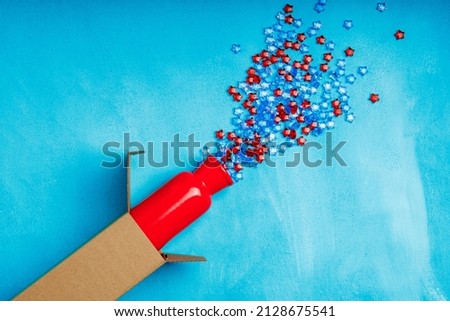 a red ceramic vase protrudes from the box, stars fall out diagonally from the vase. gift with fireworks from the stars