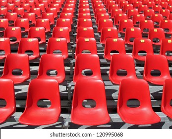 Red chairs of empty stadium but ready to accommodate the fans during the match - Powered by Shutterstock