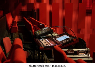 Red Chairs In The Movie Theatre With The Sound Mixing Desk / Sound Monitor In The Middle.