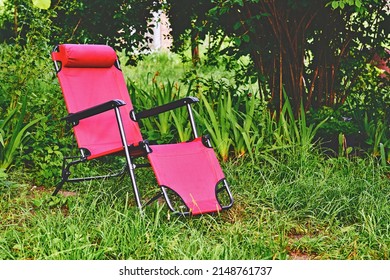 Red Chaise Lounge Chair On Summer Green Meadow