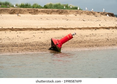 Red Channel Marker Buoy At Low Tide