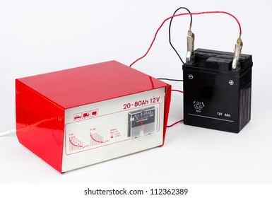 Red Charger Connected To A Black Motorcycle Battery