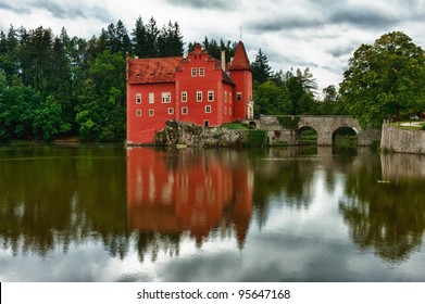 The red chateau Cervena Lhota in the the Czech Republic with a dramatic sky. Water Reflection - Shutterstock ID 95647168