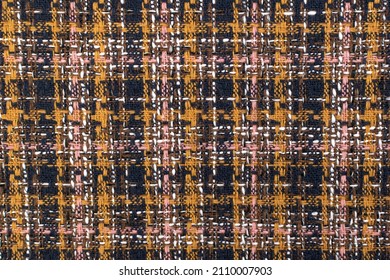 Red checkered fabric with colored threads. Scottish wool. Fabric for a plaid coat and suit. Close-up. Background