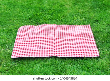 
Red checkered tablecloth on the grass