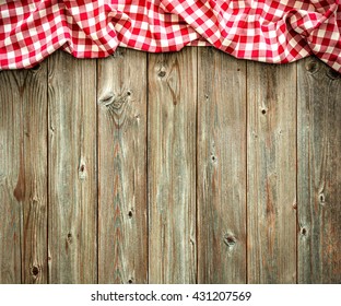 Red checkered tablecloth on wooden table - Powered by Shutterstock