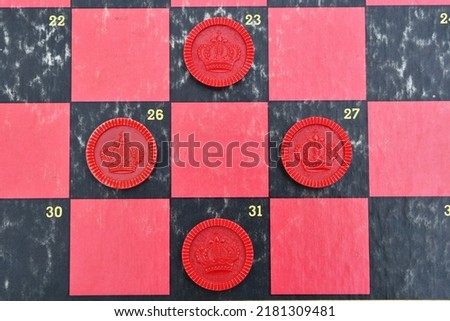 Red checkers on a checkerboard