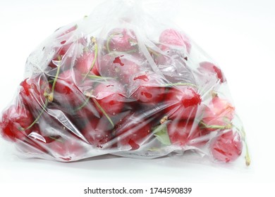 red cherries in a transparent tarnished plastic bag